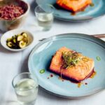 Judy Joo Instagram - Delighted my Green Chilli Glazed Salmon recipe has been featured in @cityamtravel! This dish is packed with a wonderful blend of spicy, sweet, and umami flavours. Here's a brief run-down for you to have a go at home: 1️⃣ Glaze: Gently fry finely chopped garlic and jalapeños in vegetable oil until softened. Mix together soy sauce, brown sugar, and rice wine vinegar. Add to the pan, stir well, and simmer until reduced by half. Finish with a drizzle of sesame oil. 2️⃣ Spring Onion Salad: For the dressing, combine soy sauce, rice wine vinegar, gochugaru (Korean chilli flakes), roasted sesame oil, sesame seeds, and sugar. Cut spring onions into thin strips and immerse in ice-cold water until they crisp up. Toss in the dressing. 3️⃣ Salmon: Heat oil in a pan and fry the salmon fillets until golden brown and cooked to your preference. Arrange salmon on plates, spoon over the glaze, and garnish with the Spring Onion Salad and green chilli slices. Add a pinch of silgochu for an extra kick. Serve with yuja pickles and a side of cooked rice. Enjoy your meal! 🍴 What recipe would you like to see next? Let me know in the comments! And don't forget to visit my website for more delicious recipes. For the full recipe and article, head over to #CityAM. Don't forget to share your culinary creations with us using #GreenChilliGlazedSalmon. Happy cooking! 🍳 • • • • • #koreanfood #salmon #chef #cheflife #chefsofinstagram #cook #cooking #chefs #fish #truecooks #ChefLife #Foodie #FoodPorn #InstaFood #Foodstagram #ChefsofInstagram #FoodPhotography #FoodGasm #FoodLover #FoodBlog #FoodPassion #FoodArt #FoodInspiration #FoodieLife #Cooking #Gourmet #FoodCulture #FoodieGram
