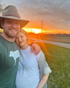 Kassandra Clementi Instagram - I’d firstly like to state that fortunately for my midline and uterus, these pictures are old. We got ENGAGED 💍 just over a year ago. Dan was fresh from a rescue covered in goat shit, I was waddling like I swallowed a ford focus, I had also drooled on my shirt during a recent nap, the sunset was beautiful (hallelujah for something nice), it was perfect and perfectly us. We’ve said “we should start planning a wedding” and gestured around vaguely at least once a week with no follow through because that bulbous belly is now a giggling, crawling, center of our universe who is better than everyone you know and who has the time.