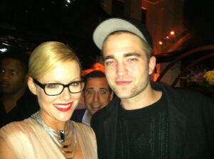 Kathleen Robertson Instagram - Miss wearing red lipstick. Borrowed jewelry and meeting new people.....this ones for you @basilpix #robertpattinson #lifebeforecovid #nomasks