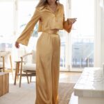 Katrina Scott Instagram - KSL in gold 🥂This set is available now with 2 gifts with purchase— the Carmen Handbag Del Sol visor… perfect for holiday gifts! The Belle pant and blouse are beautiful for holiday celebrations & NYE! These pieces were made for you locally here in LA by all female seamstresses ✨ Shop at KSLthelabel.com What should I design next? Leave your requests below ☺️ @ksl.thelabel