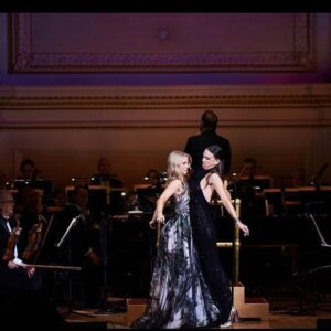 Kelli O'Hara Instagram - #photodump. I’m still misty about this past Friday night with my “partner in crime” @suttonlenore and our evening with @thenewyorkpops led by Maestro @stevenreineke @carnegiehall . There are so many people who made such a grand experiment come off without a hitch, so I must thank them! First of all, the 2 women who inspired the evening (and joined us via
voiceover🥹 ) #dameJulieAndrews and #carolburnett
❤ ❤ . We had wonderful writing and direction by #DickScanlan and additional writing by @katecjames . Our choreographer was the badass @edsciotto and we shared the stage with him and 3 more fabulous friends @ericamansfieldny @sherissespringer and @mrawayne. My right hand man @liptongram was ever by my side as was the incredible #MichaelRafter. It took so much incredible work by folks like our line producer @nikki_fergie and associate director @meganefarley, our orchestrators and everyone @thenewyorkpops to make this happen. I am forever grateful. I also want to thank our stylist @emilysanchezstyle for our #lewks with a huge shout out to @lindsayblockstyle and
@jilloshrymakeup for my #hmu👏 .

My looks in order of appearance:

Opening Dress: @randirahm
Shoes: @stuartweitzman
Bracelet: @Mariajosejewelry
Rings: @shopmodernmoghul

Pink gown with flowers: @Marchesafashion
Shoes: @ninashoes
Rings: @shopmodernmoghul, @itajewelry
Bracelet: @Nadrijewelry

Cowboy look 
Jeans: @everlane 
Shirt: @wrangler 
Boots: Crown vintage co @dsw

Red cocktail dress: @michaelkors
Shoes: @Sam_edelman
Bracelets: @Grownbrilliance, @Aliweissjewelry
Rings: @shopmodernmoghul, @itajewelry 
Earrings: @shopmodernmoghul

Suit: @michaelkors
Shoes: @ninashoes
Rings: @Grownbrilliance
Necklace: @Mariajosejewelry
Earrings: @Nadrijewelry