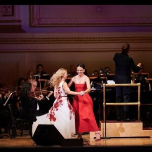 Kelli O'Hara Instagram - #photodump. I’m still misty about this past Friday night with my “partner in crime” @suttonlenore and our evening with @thenewyorkpops led by Maestro @stevenreineke @carnegiehall . There are so many people who made such a grand experiment come off without a hitch, so I must thank them! First of all, the 2 women who inspired the evening (and joined us via
voiceover🥹 ) #dameJulieAndrews and #carolburnett
❤ ❤ . We had wonderful writing and direction by #DickScanlan and additional writing by @katecjames . Our choreographer was the badass @edsciotto and we shared the stage with him and 3 more fabulous friends @ericamansfieldny @sherissespringer and @mrawayne. My right hand man @liptongram was ever by my side as was the incredible #MichaelRafter. It took so much incredible work by folks like our line producer @nikki_fergie and associate director @meganefarley, our orchestrators and everyone @thenewyorkpops to make this happen. I am forever grateful. I also want to thank our stylist @emilysanchezstyle for our #lewks with a huge shout out to @lindsayblockstyle and
@jilloshrymakeup for my #hmu👏 .

My looks in order of appearance:

Opening Dress: @randirahm
Shoes: @stuartweitzman
Bracelet: @Mariajosejewelry
Rings: @shopmodernmoghul

Pink gown with flowers: @Marchesafashion
Shoes: @ninashoes
Rings: @shopmodernmoghul, @itajewelry
Bracelet: @Nadrijewelry

Cowboy look 
Jeans: @everlane 
Shirt: @wrangler 
Boots: Crown vintage co @dsw

Red cocktail dress: @michaelkors
Shoes: @Sam_edelman
Bracelets: @Grownbrilliance, @Aliweissjewelry
Rings: @shopmodernmoghul, @itajewelry 
Earrings: @shopmodernmoghul

Suit: @michaelkors
Shoes: @ninashoes
Rings: @Grownbrilliance
Necklace: @Mariajosejewelry
Earrings: @Nadrijewelry