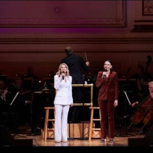 Kelli O'Hara Instagram - #photodump. I’m still misty about this past Friday night with my “partner in crime” @suttonlenore and our evening with @thenewyorkpops led by Maestro @stevenreineke @carnegiehall . There are so many people who made such a grand experiment come off without a hitch, so I must thank them! First of all, the 2 women who inspired the evening (and joined us via
voiceover🥹 ) #dameJulieAndrews and #carolburnett
❤ ❤ . We had wonderful writing and direction by #DickScanlan and additional writing by @katecjames . Our choreographer was the badass @edsciotto and we shared the stage with him and 3 more fabulous friends @ericamansfieldny @sherissespringer and @mrawayne. My right hand man @liptongram was ever by my side as was the incredible #MichaelRafter. It took so much incredible work by folks like our line producer @nikki_fergie and associate director @meganefarley, our orchestrators and everyone @thenewyorkpops to make this happen. I am forever grateful. I also want to thank our stylist @emilysanchezstyle for our #lewks with a huge shout out to @lindsayblockstyle and
@jilloshrymakeup for my #hmu👏 .

My looks in order of appearance:

Opening Dress: @randirahm
Shoes: @stuartweitzman
Bracelet: @Mariajosejewelry
Rings: @shopmodernmoghul

Pink gown with flowers: @Marchesafashion
Shoes: @ninashoes
Rings: @shopmodernmoghul, @itajewelry
Bracelet: @Nadrijewelry

Cowboy look 
Jeans: @everlane 
Shirt: @wrangler 
Boots: Crown vintage co @dsw

Red cocktail dress: @michaelkors
Shoes: @Sam_edelman
Bracelets: @Grownbrilliance, @Aliweissjewelry
Rings: @shopmodernmoghul, @itajewelry 
Earrings: @shopmodernmoghul

Suit: @michaelkors
Shoes: @ninashoes
Rings: @Grownbrilliance
Necklace: @Mariajosejewelry
Earrings: @Nadrijewelry