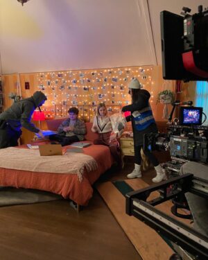 Kerry Butler Instagram - Hey!  This is what I was doing the last time I got covid!  #Honorsociety comes out tomorrow @paramountplus .  I loved this script by @davidagoodman1 and direction by @oranzegman- But don’t take my word- look at this rave review in @variety .  Here are some BTS with @angourierice and @gatenm123 Third picture shows one of my outfits- nothing more flattering than an apron over a chunky sweater 😂 #momswholovetobake Last picture - i had a fireplace in my trailer!! FANCY!  Thanks  @bardenschneecasting #tiffanymakcasting  for helping to make it work with my crazy schedule!!! 💕 #honorsocietymovie Also i’m back in @beetlejuicebway on sunday!! #stupidcovid