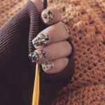 Kirsten Storms Instagram - Almost done crocheting a sweater for Harps (using @lionbrandyarn Pound of Love in “Pumpkin Pie”….this color 😍) While I’m at the last portion of my stay on “sleeve island” I’ve been admiring my new nails by @nails.qvtr.winston. Rhinestones are from @naildadshop and I want to put them on everything I own. #crochetersofinstagram #nailart #lionbrandyarn