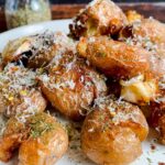 Laura Vitale Instagram - These one pan crispy potatoes were the potato winner of 2022 and I simply couldn’t resist sharing them again because they are so unbelievably good and easy!! Add baby potatoes in a deep skillet and cover with water (about half an inch above the potatoes) add a generous glug of olive oil, about 1/4 cup, and a hefty pinch of salt, then bring to a boil, once the water is reduced by half, add cloves of garlic fresh herbs and give them a gentle squeeze then let the magic of cooking do what it does, the water will evaporate and the oil will crisp them up to perfection, make sure you flip them around to get evenly crisp. Serve with an extra grating of parm and indulge 😘