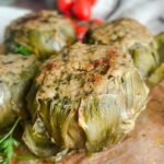 Laura Vitale Instagram - In this house, we keep recipe traditions alive especially around the holidays. Artichokes are alwaysssssssss on the table at Easter, either boiled (or steamed) or stuffed (and most of the time both) and they are so sensational you can’t even imagine!! I don’t really measure the filling (but i hope to shoot it for you in depth this week if time allows because I make them all spring long!!) breadcrumbs , cheese, garlic, parsley, lots of oil and good pinch of salt. Cook low and slow in enough water and to come up half way and a good drizzle of oil and healthy pinch of salt. Keep topping off the water to keep it at that halfway mark, cook about an hour and if you’d like (and I recommend) broil for a few minutes. Serve with some of the brothy water drizzled over the top and live your best life one bite at a time babes 😍