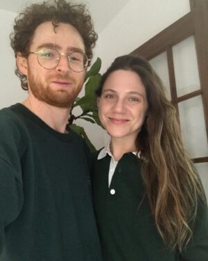 Lauren Collins Instagram - Reposting @jonathanmalen to show us in our most natural state. Him - wearing my cast sweatshirt from a 1997 community theatre production of Lillian Hellman’s “The Children’s Hour”. And me - wearing the men’s Zara shirt I bought him for Chanukah,  smiling through the inevitable fate of being forced to finally watch Cast Away for the first time. 

Bonus swipe for Charlie in his most natural state eating crackers, oblivious  to it all. 
#happyholidays folks