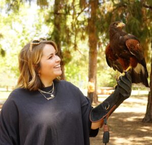 Lee Newton Instagram - Was I 💯 convinced that this Hawk was a human man trapped in a bird body and needed me to break his bird curse with a smooch. Yes. Can you see the palpable sexual tension betwixt the two of us in these photos- UHHH, YES. Thank you @hawkonhand for introducing us, and for such an educational, delightful time! (Legitimately if you’re in the LA  area this was such an INCREDIBLE EXPERIENCE!!! Do it!!!) 
Ps. The owls name is Archie 🥹🦉!!!