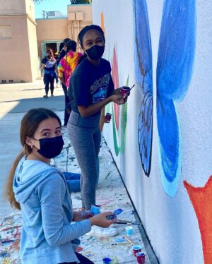 Lidya Jewett Instagram - helping put a library where there was none. 9000 books and beautiful murals. so so excited for the students at @cechs.asb in Compton.