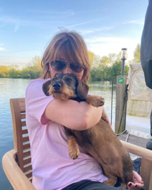 Lorraine Kelly Instagram - Love our wee @rubyisasausage - a lovely sunny evening - and lots of cuddles #sausagedog #cute #cuddles #love