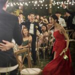 Louisa Mak Instagram - 唔少朋友都問我，哇搞三場婚禮，咪好辛苦！的確係，完事後直情要瞓足成個禮拜先recover到。其實唔係因為想搞到好「盛」大，而係源自於一個儘量make everyone happy嘅初心。 由於我和盛生好怕衝突、唔開心，所以我哋好早就決定將婚禮分幾次搞，而每一場都有各自嘅主角。大大小小嘅選擇就因住主角嘅需求而決定。 第一場盆菜宴，主角係老爺奶奶。我地盡跟圍村傳統，賓客絕大部份都係佢哋嘅親戚和朋友，而表演嘉賓方面，就邀請了奶奶很喜愛嘅李龍基先生。 第二場係正常擺酒，主角就係麥生麥太，菜式、流程、程序等都以佢地嘅意見為首。圍數全部歸佢地兩老，只受場地所限而唔使同對家協調😌 婚紗款色都迎合佢地喜好 至於第三場，就係更瘋狂嘅party，主角終於係我同盛生喇✌️因為之前已經take care 咗雙方父母嘅要求，呢次我哋就可以盡情選擇自己鍾意嘅嘢 - 戶外草地、樂隊歌曲、西式食物、無限酒精🫢… 爸爸媽媽雖然唔識欣賞，但係都好盡力去嘗試投入 😂 呢個安排，幫我地避免咗唔少衝突。男女家唔使爭圍數、長輩和後輩唔使爭論食物和形式係中式定西式；頭兩場我和盛生安分守己地做好兒子和女兒的本分，再於尾場玩得好盡興🥳（盡興到啲相都唔出得街🤪)。咁壞處就係… 真係好攰🫠。 每人屋企都唔一樣，家家有本難念的經，以上純粹share下我倆嘅經驗。總括來講，我爸爸媽媽、老爺奶奶也是非常隨和，我們非常幸運，而最後似乎各人都開心。不過同時都提醒一句，家人話「冇咩所謂，簡簡單單就OK」呢句說話… ummm.. 千祈唔好盡信呀🤪唔知你哋又有冇啲咩婚禮後嘅insight呢？喺comment share吓吖！ 最後，多謝 @agnesb_cafefleuriste 為三場婚宴都提供無限量超好食蛋糕😌 無論喺中式定西式婚宴、男家定女家、長輩定小朋友，蛋糕都一樣咁受歡迎😍 #勁甜麥 photo 1, 2, 5, 8 @taptsov_photography photo 4 @orbsproductionwedding photo 6, 7, 9, 10 @stein_image
