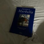 Maja Bohosiewicz Instagram – Dostałam dzisiaj na prezent urodzinowy piękną książkę album o Marbelli od dobrej duszy @malina_blanska –  która jest moją nową ( starą? Ta historia jest ciekawa) koleżanką na emigracji.  Mówiłam Malinie, że niczego tutaj nie znam, nie zwiedziałam, nie odkryłam, że sama Marbella jest dla mnie cudnym miejscem do życia ale nie wiem czy poleciałbym te destynacje na tygodniowe wakacje. I co dzień ( choć to pewnie przesada) ale co jakiś czas odkrywam jakiś mały skrawek prawdziwej Marbelli, jakąś uliczkę z cudnymi kwiatkami w oknach, jakiś sklep który z zewnątrz pokryty jest płytkami azulejos – w typowo hiszpański wzór, znajduje knajpkę z plastikowymi krzesłami w której zjadamy przepyszną rybę i mogę powiedzieć, że na prawdę odnajduje tu swoje ścięzki i czuję dobrze od kiedy pani z warzywniaka –  fruteria de Adela- wita mnie radośnie i mówi, że specjalnie dla mnie zostawiła 5 buraków ( czyli remolacha). Przeglądam ten album i widzę wiklinowe kosze z gałązkami oliwnymi i wnętrza które ewidentnie są inspirowane kulturą i sztuką Maroka, piękne stare haciendy w kolorach od błękitu, przez różowy aż do czerwonego z białymi koniecznie oknami, drzewka pomarańczowe i cytryny które także rosną na moim podwórku. Zachwycają mnie inne rzeczy niż kiedyś i o dziwo jestem gotowa postawić coś na widoku w ramach ozdoby. Wiecie o mi chodzi? O to natręctwo chowania wszystkiego do środka szafek żeby nic nie było na widoku – aż tu nagle człowiek kupuje gliniane wazoniki i ręcznie malowane talerze które chce powiesić na ścianie. 
Malinko… dziękuję za piękny prezent. Mam nadziej że uda mi się pokazać wam tutaj Marbelle która widzę na zdjęciach w tym albumie ❤️ jeżeli macie jakieś miejsca godne polecenia do zobaczenia, albo po prostu godne pójścia i kontemplowania albo choćby wypicia kawy w pobliżu – dawajcie znać! #marbella