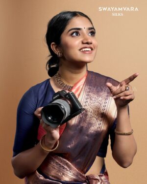 Malavika Manoj Instagram - Capturing Elegance 

 @malavika_manojj wearing: Traditional copper tissue saree in self design with contrast defined border in peach and navy blue combination

#swayamvarasilks #malavikamanoj #joemovie
#kerala #trending