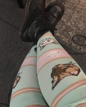 Mara Wilson Instagram - HAPPY BOOK BIRTHDAY, #OneForAll! To celebrate this amazing book (link to buy in bio!) with a protagonist who has #POTS, written by an author with POTS, and narrated by audiobook narrator with POTS (me!), here are some COMPRESSION SOCK BOOTH SELFIES! Here are the cute compression socks I wore while recording this amazing book.

Not only is it great #OwnVoices representation, it’s also a fun, swashbuckling, romantic, thrilling YA retelling of The Three Musketeers! So thrilled to lend my voice to this awesome book. Link in bio, be sure to let me know who your favorite characters are! And maybe your favorite compression socks 😂 ⚔️ 💜 #sisterhoodofthestabstab #pots #posturalorthostatictachycardiasyndrome #dysautonomia #disabledkidlit #potsawareness #yabooks #audiobooks #compressionsocks #compressionsocksrock