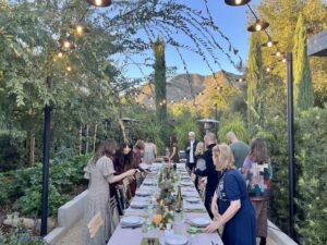 Mary Steenburgen Instagram - Grateful. Backs turned as everyone heads for food. Please do zoom in on my centerpiece( my longtime friend Linda ( navy dress) helped me put it all out). And my three granddaughters did the place cards.  We all made the yummy food. Hope you all had a blessed day. 🧡