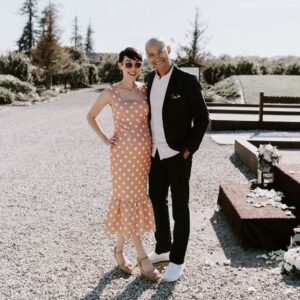 Michelle Kim McCoy Instagram - A sweet pic of @kellydlux and me just because I like him lots and am especially thankful for how hard he’s been working in preparation for our growing family! He’s been even attending my photo shoots during his free time to be my gear caddy, hydration monitor/snack provider and second shooter to lighten my load and make sure I don’t pass out ☺️ Thx @niki_camps for documenting this rare occurrence of us attending a wedding rather than working one!
.
.
.
.
.
#pregnantstyle #matenityfashion #momtobe #mothertobe #mommyblogger #expectantmother #expectantmom #momfashion #mommyfashion #stylethebump #dressthebump #maternityshoot #maternityclothes #maternitydresses #cutematernityclothes #pregnancyclothes #ootd