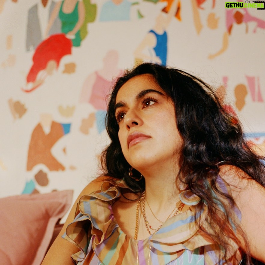 Mona Chalabi Instagram - Thank you @time for naming me in your 100 next list. Just patiently waiting for everything to go wrong because these past few months have been a bit too fruity. Photo by @heathersten of me wearing my mum’s dress in front of a painting in progress.