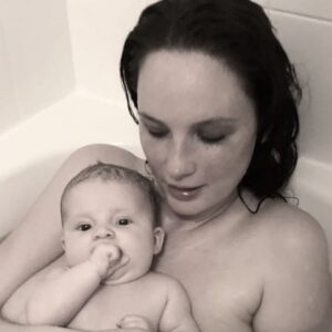 Olwen Catherine Kelly Instagram - L❤️VE - I didn't know there was anything missing in my life before you and your father came in to it.

*This is a third attempt to share a moment spent with my daughter captured by my partner.
My already out of focus nipple is now completely censored.
Swipe for the absolutely absurd reason someone reported my photo and why it was deleted by @instagram

I nourish my child's body with that nipple, her soul with interaction and our bond with skin to skin to contact.
When she is immersed in water and listening to my voice she sucks at the air (followed by her hand or thumb) because that is what she did when she was in the womb. 
If you are offended by that, I am not sorry. 

Note:
#skintoskincontact is a medically advised practise.
#breastfedbaby
#breastfeedingawareness
#breastfeeding
