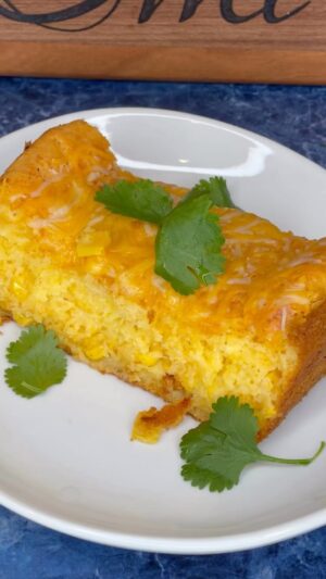 Omallys Hopper Instagram - Corn Bread Cheesy Cake 🙌🏽🙌🏽🙌🏽 

Ingredients: 
-2 boxes of jiffy corn bread mix 
-4 eggs 
-1 stick of unsalted butter melted 
-1/2 tsp Baking Powder 
-1 1/2 blocks of cream cheese
-2 cups of shredded cheese (you pick) 
-1 can of corn 
-1 can cream of corn 
-pinch of salt 
-1 tbsp sugar 

Mix well and place in oven at 350 for 40 minutes