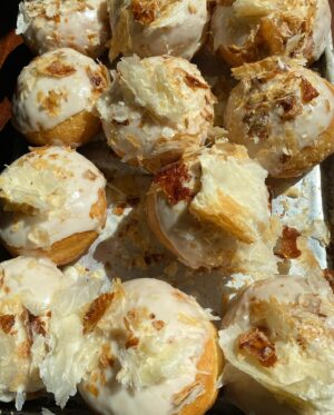 Paola Velez Instagram - Quesito donas (donuts) | cream cheese filling, leche icing, candied puff pastry 

#quesito