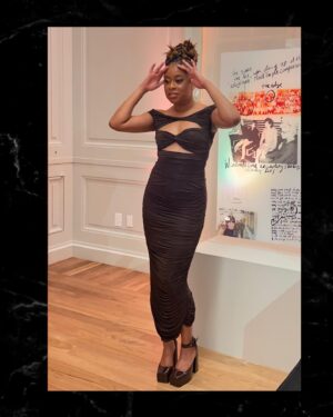 Phoebe Robinson Instagram - When I was asked to interview my friend/mentor Bono at a private book party (hosted by @Bloombergdotorg) celebrating his NYT memoir “Surrender,” I thot to myself, “In my book club, we all getting half chubs,” hence me serving body-ody-ody in a Hershey’s chocolate bar 🍫 wrapping. Jokes aside, this was legit one of the best days of my life.
⠀
Like thirteen year old me would’ve geeked over the opportunity and also fluffed out her Civil Rights era banyang. Seriously, when I was younger I looked I could’ve been in what was originally the Little Rock Ten, but alas I missed it all because I overslept the night before, so Nine it was! ANYWAY! The point is sometimes you dream of and hope for and manifest certain things, but the universe has a way of surprising you with even more when you surrender to it.
⠀
To kiki with a person whose music and philanthropy has meant so much to my life was a dream come true. To hear the way he speaks of and writes about Ali, his wife of 40  years moved me to tears. The way his band mates - Edge, Adam, & Larry - have bettered him in ways that he’s long known and ways he’s still discovering is touching without being overly sentimental. And to watch him take his passions seriously in one breath and then also take the piss out of himself the next is a masterclass in authenticity. He’s a thoroughly self-possessed person, which is probably the most beautiful thing about him.
⠀
So thanks, B, for the pleasure of your friendship, the gift of your generosity, and welcoming me deeper into the @red family by having me join the Advisory Board (I know B said Creative Council, but it’s the Advisory Board). I can’t wait to get to work and help the debilitating presence HIV/AIDS still has in this world. You, (RED), and so much more continue to make this the ride of a lifetime. So I’mma buckle up and keep dressing like some dude’s future second wife that he’s about to meet. 😂😏🤷🏾‍♀️. #FBF
⠀
Hair: @lurissaingridhair 
Makeup: @fatimotisadare 
Styling: Moi
Dress: @alexperryofficial 
Shoes: #BottegaVeneta
Earrings: @cloverpost