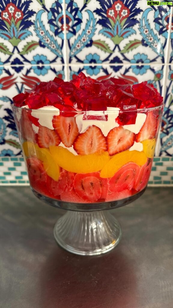 Poh Ling Yeow Instagram - Ok I finally got my shizen together this year & wrote a recipe for the retro Yeow trifle which is ‘special’ because it uses NO fresh ingredients bar the strawberries 🤔. Every time I’ve deviated ever so slightly into fancy, someone will comment “HOW INTERESTING YOU USED SOUR CHERRIES & HOMEMADE CUSTARD THIS YEAR” - code for “Why did you turn this into something unpredictable”. Anyhoo, i guess the moral is if it ain’t broke - enjoy! Merry Holidays everyone!!! ♥️⭐️ YEOW FAM RETRO TRIFLE 3 packets 🍓 or raspberry crystals 4 Tbs powdered gelatine or 10g sheet gelatine 1 x 6 pack mini jam rollettes, sliced 1.5cm 2 punnets strawberries, slice enough to cover the diameter of the trifle bowl, cut the rest into 1cm cubes. 825g tin sliced peaches, drained 2-3 cups custard (powdered kind - make using packet instructions or u can use home made creme patt of course) 1 cup thickened cream, whipped with 2 Tbs full caster sugar & 1 tsp vanilla or strawberry essence until medium - stiff peaks Make 2 packets of the jelly following the packet instructions but add the extra gelatine. Stir until all the crystals are dissolved then pour into a flat 25x20cm-ish tray or dish. Chill in fridge for 2 hours or until set firmly. Make the remaining packet of jelly using regular packet instructions. Set aside. Arrange the jam rollettes on the bottom of the triffle bowl (about 4L capacity). Pour the warm jelly mix over the rollettes making sure all the pieces are soaked through. Layer as follows: 1/2 of the custard, peaches, remaining 1/2 of the custard, strawberries, whipped vanilla cream. To finish, slice up your finger jello into cubes and rain them over the cream piling them as high as possible. Chill for 2 hours so the jelly in the bottom is set. Serve with a smol shovel, dive in and hope jelly cubes don’t wind up bouncing all over your mum’s carpet 🤭😚