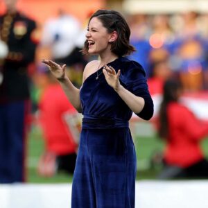 Sandra Mae Frank Instagram - This has been an incredible journey to perform at the #SuperBowlLVI this year in Los Angeles!

I am honored to join the group of deaf legendaries that have performed #NationalAnthem and #AmericaTheBeautiful in the past at #SuperBowl. 

I can’t wait to pass the torch to the next one!

It’s been an incredible year of deaf representations in the entertainment industry worldwide. Yes, we still have more work to do as we continue to thrive the way for the future generations of deaf performers/entertainers/creators in the entertainment industry. We are in this together! #LETSGO

Many more to come! 🔥

Thanks to @NAD1880 for a great opportunity! 🤟🏻🤗

Also, #WawaSnipe & #SeanForbes were on fire performing the HalfTime Show! #ShoSumLuv! 😎

Photo - #KevinCCox
Outfit - @SomethingNavy
MHU - @Leibi_Carias 
ILY Necklace - @RoseByander 

#DeafArtists #Singers #ASL #MickeyGuyton #JheneAiko #DeafMusicArtists #DeafAndLoud #Joy #PreShow #HalfTimeShow #LGBTQ🌈

[image description]
Photo 1 - Sandra Mae, short wavy hair, wearing a stunning royal blue jumpsuit with a partial long sleeve, ILY necklace, and pride progress pin. Both of her hands are up and closed. She is smiling.
Photo 2 - Same look as photo 1, but her hands are now open, and she’s smiling bigger.