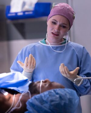 Sandra Mae Frank Instagram - Constantly in awe of Dr. Wilder’s strength and drive to go beyond for her patients 💙

New Episode of #NewAmsterdam airs tonight on NBC at 10/9c!

#DamFam #DrWilder

[image description]
Sandra Mae as Dr. Wilder in blue scrubs and a pink cap, talking to a patient laying while facing her.