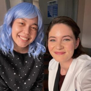Sandra Mae Frank Instagram - Check out this stunning actor, @KatieLeeHill, as #Willow in last night’s #NewAmsterdam! I loved working with her! 🤗 

#DamFam #TheCrossover💙

[image description]
Two women, Katie as Willow with baby blue hair and Sandra Mae as Dr. Wilder in her lab coat. Both are looking at the camera, smiling.