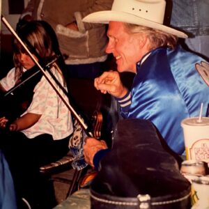 Sara Watkins Instagram - This weekend we lost a legendary fiddler, and a man who hugely influenced so many of us when we were coming up as young players.  When I was about 8, he sold me my first good fiddle - a 3/4 size.  It was way too big for me for at least a year or two but it sounded great and I was so proud that I got it from Byron. That’s the one I’m playing in these first two photos.  Alison Kraus was playing our favorite local festival called Follows Camp, and Byron organized a jam so all of us kids could play with her.  Byron, his wife Bette and daughter Becca were always welcoming and my heart and love are with them.  I remember going to their house shortly after the Northridge earthquake and he told stories of near misses and mentioned after the quake, the water level of his pool was a foot lower, and all the fruit on that side of the orange tree had been knocked to the ground.  Seemingly from a big wave.  It’s funny the things that stick with you.

If we came to one of Byron’s shows, be it with “The LA Fiddle Band” or “California” or anything else, he’d almost always invite us up to play on a tune with them.  It made me want to work so I’d be deserving of the opportunity if and when the next chance came in hopes he’d see that I’d been practicing.  Throughout his long influential life, Byron took so many of us young players under his wing and taught us about performing and jamming by example. I’m so grateful for his contribution to my life, and for his bow arm that, to me, defined his style.  I have so many memories of being around Byron, I wish I had more photos, but I’m grateful for these which my parents and aunt Joanie recently sent my way.