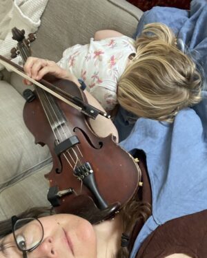 Sara Watkins Instagram - I tried to get some practice in during her nap and heard her sweet footsteps come down the stairs much earlier than I’d hoped.  I was promptly told by my daughter that the fiddle is annoying and I should try play quieter.  Listen kid, I feel you.  I was given 10 or 15 more mins in of practice while she dozed on my lap and my heart went boom.