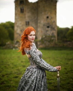 Sasha Alsberg Instagram - 👑 She never cared for a crown. She preferred a sword. 🗡️ this dress makes me feel like I stepped off the pages of a book. I wonder what the title would be….
Dress: @aclotheshorse’s from @chotronette (SO BEYOND STUNNING!)
Photo by: @friendofthekingfisher 
#ireland #ladyknight #romanticacademia #womenwithswords #darkacademia #booktok #tog #fantasybooks #fairycore #faerie #visitnorthernireland