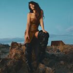 Serinda Swan Instagram – This shoot was taken in the desert at Mojave Moon Ranch, and right as the sun was setting we ran to the top of this mountain for the most beautiful light Definitely not easy in these boots, but the picture was well worth it. 😂
Exclusive for @ladygunn 

Photography:  Valerie Burke @burkephotography 
Stylist: Sofia Popkova @iamsofiapopkova @stylebysofiapopkova
Make Up: Marlena Von Kazmier @marlenavonkazmier_mua
Hair: Olya Romanenko @o.r.hair
Styling Assist: Anastasia Buriak @aintsweetlikesuga & Oksana Masalyko @oxanamas
Wearing:
Leather dress: @attickoncept
Boots: @berhasm_global – @tata_la
Necklace: @attickoncept