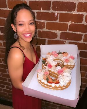Shelby Simmons Instagram - Had a wonderful birthday, doing what I love! And I was surprised with this magnificent cake from my tribe! @crumbles__patisserie your work is exquisite 💕🎂 Here’s to 22 🥂