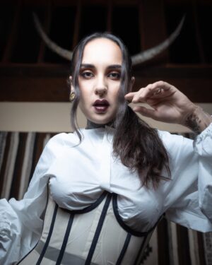 Tatiana Shmayluk Instagram - “Am I Evil? Yes, I Am”
•
🕷️Halloween’s around the corner! 🕸️ And as most of you adore this holiday, I thought it would be a perfect time to drop another small selection of prints (LIMITED). This one is a lost gem that I absolutely love because of the turn the photoshoot had taken (the horns are a part of a bull’s skull hanging behind my head, which helped me to transform myself into this mystic  character). 

Corset: @clantwentyone 
#selfportraitphotography 
•
•
Shop @tatisrealm ✨(link in bio).