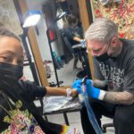 Thandiwe Newton Instagram - NOW I’m home. Got my post @westworldhbo Season 4 ink done by my homeboy @miles_chappers Every milestone is marked by Miles. Booker came along to watch. He designed a tattoo for me too, thank you baby. @frithsttattoo ☠️ go hard or go home Xx Thandiwe Oh yeah - wearing @ashish dope hoodie and @chanelofficial watch @bella_freud sparkly leggings that you can’t see 😋 And @sacaiofficial boots that I want grafted onto my ankles like permanent hooves. I pissed IN the f***ing toilet 🙏🏽
