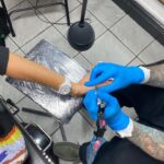 Thandiwe Newton Instagram - NOW I’m home. Got my post @westworldhbo Season 4 ink done by my homeboy @miles_chappers Every milestone is marked by Miles. Booker came along to watch. He designed a tattoo for me too, thank you baby. @frithsttattoo ☠️ go hard or go home Xx Thandiwe Oh yeah - wearing @ashish dope hoodie and @chanelofficial watch @bella_freud sparkly leggings that you can’t see 😋 And @sacaiofficial boots that I want grafted onto my ankles like permanent hooves. I pissed IN the f***ing toilet 🙏🏽