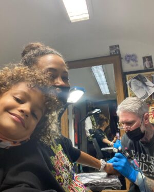 Thandiwe Newton Instagram - NOW I’m home. Got my post @westworldhbo Season 4 ink done by my homeboy @miles_chappers 

Every milestone is marked by Miles. 

Booker came along to watch. He designed a tattoo for me too, thank you baby. 

@frithsttattoo ☠️ go hard or go home

Xx Thandiwe

Oh yeah - wearing @ashish dope hoodie and @chanelofficial watch @bella_freud sparkly leggings that you can’t see 😋
And @sacaiofficial boots that I want grafted onto my ankles like permanent hooves.

I pissed IN the f***ing toilet 🙏🏽