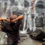 Victoria Spence Instagram - Mikes dumped until he can offer me this level of commitment for my holiday photos 😭🤣 Absolute LOLs!! If you’re after and authentic waterfall experience I probably wouldn’t recommend this waterfall because it’s definitely all about people getting photos and videos , but if you want to see a stunning waterfall, have a laugh with and get some unreal photos by the guys there and feel like everyone’s supporting you while it’s your turn, add it to your Bali bucket list- and get there EARLY!🌴📸 #bali #waterfalls #funny