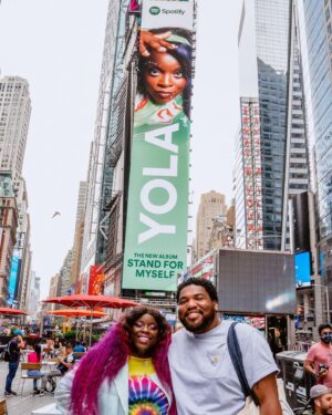 Yola Instagram - I can’t thank @spotify enough for the support they’ve shown for the release of Stand For Myself, look at this here billboard, in TIMES SQUARE no less! I was so fortunate to catch up with my friend & photographer @jross_smith to witness this together. Now @spotify are offering you guys a Fans First pre-sale for the tour dates we announced yesterday. If you have been listening on Spotify check your emails to see if you have the pre-sale code. Happy ticket buying! 
📷 1 & the billboard image @jross_smith 
2 of @jross_smith celebrating our collective majesty by @direimage