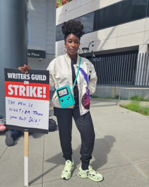 Adamma Ebo Instagram - Me
My Gameboy Bag
& my Tekken bomber jacket were not playing about the videogame themed day of the WGA Strike at Universal. 

Way beyond time to do right (pun intended?) by writers. 

📸: @johncerrito

#wgastrike #wgastrong #sneakers #sneakeraddict #adidas #blackgirlsneakerjoy #gamer #gamerlife #gamerstyle #tekken #gameboy #personalstyle #iwearwhatiwant #secondhandfashion #secondhandstyle #shopsecondhand #shopyourcloset