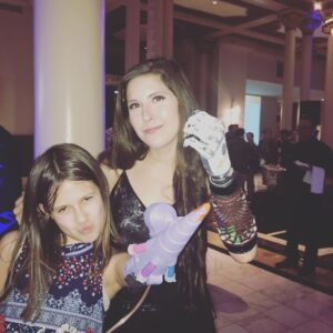 Aimee Mullins Instagram - Glitter Parade!! Jordan Reeves showing me her self-designed Unicorn arm that shoots biodegradable glitter via compressed air out of the end! The Future is Female. @jordanjustright #ProjectUnicorn #3dprinting