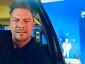 Alan Ritchson Instagram - You’re playing Reacher. You started filming the season in the summer, but a strike pushed you into the bitter cold of an uninhabitable Toronto winter. As a result, the driving scenes aren’t so drivey anymore.

The windshield has been removed so the camera doesn’t see itself. It’ll be put back in in post. Everyone has on eye protection but you. Zirks are being shot at you from all sides. They’re basically paintballs filled with black powder, zirconium and bird seed. They can start a fire and they definitely create a debris field. Your eye twitches at the thought one clipping your dusty retina. 

You’re tasked with driving across a property that currently only exists in your mind, while the camera pushes into your face through an invisible windshield and you’re blasted with the Golden Corral of bird food. 

To complicate matters further, the car is off so the fumes don’t turn the soundstage into the Jonestown Massacre. Which means there’s no power steering and the tires are under 8 thousand pounds of truck. The steering wheel makes you look weak. Everyone laughs at you. You take solace in the fact that a Craig’s cookie isn’t too far away. You love cookies. You eat them all the time. 

Can you sell the explosive drive without over doing it? Or are you driving Miss Daisy?