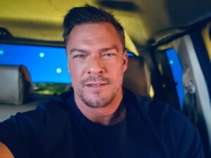 Alan Ritchson Instagram - You’re playing Reacher. You started filming the season in the summer, but a strike pushed you into the bitter cold of an uninhabitable Toronto winter. As a result, the driving scenes aren’t so drivey anymore.

The windshield has been removed so the camera doesn’t see itself. It’ll be put back in in post. Everyone has on eye protection but you. Zirks are being shot at you from all sides. They’re basically paintballs filled with black powder, zirconium and bird seed. They can start a fire and they definitely create a debris field. Your eye twitches at the thought one clipping your dusty retina. 

You’re tasked with driving across a property that currently only exists in your mind, while the camera pushes into your face through an invisible windshield and you’re blasted with the Golden Corral of bird food. 

To complicate matters further, the car is off so the fumes don’t turn the soundstage into the Jonestown Massacre. Which means there’s no power steering and the tires are under 8 thousand pounds of truck. The steering wheel makes you look weak. Everyone laughs at you. You take solace in the fact that a Craig’s cookie isn’t too far away. You love cookies. You eat them all the time. 

Can you sell the explosive drive without over doing it? Or are you driving Miss Daisy?
