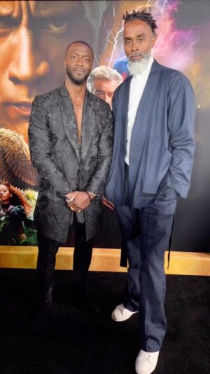 Aldis Hodge Instagram - I have to take a minute and shine a spotlight on my brotha @waraire___ .

When it came to Carter Hall’s clothes in @blackadammovie, I knew I wanted his style to reflect his entire being. So connecting #WaraireBoswell with our legendary costume designers @kurtandbart2 was absolutely a no-brainer. Those brothas collaborated and over-delivered.

So I knew when I had ideas and sketches for my #blackadam premiere looks, Waraire was the right man to bring my vision to fruition. And once again, he knocked it out of the park.

All I’m saying is for those that don’t know, now you know. The brotha is a visionary. 

You can read more about our collaboration at @vogue https://www.vogue.com/article/black-adam-star-aldis-hodge-hawkman-wardrobe-custom-watch/amp