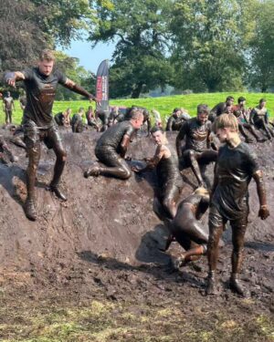 Amy James-Kelly Instagram - TOUGH MUDDER NORTH WEST 2023
••••
15km of mud, water, hills, and the wackiest obstacles since Richard Hammond and his Big Red Balls.
••••
Like Fall Guys, but real life, and you don't bounce if you fall. And you pay to do it. And you hurt for days after. And you run for way more than a couple of minutes. And there's no bright colours, it's all just grass and mud. So it's nothing like Fall Guys really. 
••••
I've been nervous about this for months - two surgeries later and I'm negotiating this event with a body that needs to do more than just train to run for a bit... There were obstacles I was on doctor's orders NOT to attempt (and I didn't, dw) But I conquered it. All 15k. And when I had to miss out an obstacle (like the two that electrocute you) I made sure I pelted it to the next one, just so no one could say I had an easy day of it 😜. We all crossed the finish line together, caked in mud, water, sheep shit, blood and sweat. And dya know what? I had a belting time. I have crap upper body strength so fell off every single set of monkey bars I crossed paths with (into the most horrible 'water'), but I did do two obstacles that triggered my claustrophobia so I'd say I redeemed myself...
••••
Matt, Will, Andy and of course Dan, who I absolutely not in a million years could have done this without, right from training to pulling me up the last few feet of that wall as I dangled from his arms. (And there's evidence within these photos that he had rather a nice time assisting me too, I guess... 😜)
••••
Can't wait to see the official photos from the event and be greeted by some ridiculous shots of me going arse over tit... @toughmudder