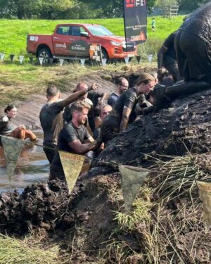 Amy James-Kelly Instagram - TOUGH MUDDER NORTH WEST 2023
••••
15km of mud, water, hills, and the wackiest obstacles since Richard Hammond and his Big Red Balls.
••••
Like Fall Guys, but real life, and you don't bounce if you fall. And you pay to do it. And you hurt for days after. And you run for way more than a couple of minutes. And there's no bright colours, it's all just grass and mud. So it's nothing like Fall Guys really. 
••••
I've been nervous about this for months - two surgeries later and I'm negotiating this event with a body that needs to do more than just train to run for a bit... There were obstacles I was on doctor's orders NOT to attempt (and I didn't, dw) But I conquered it. All 15k. And when I had to miss out an obstacle (like the two that electrocute you) I made sure I pelted it to the next one, just so no one could say I had an easy day of it 😜. We all crossed the finish line together, caked in mud, water, sheep shit, blood and sweat. And dya know what? I had a belting time. I have crap upper body strength so fell off every single set of monkey bars I crossed paths with (into the most horrible 'water'), but I did do two obstacles that triggered my claustrophobia so I'd say I redeemed myself...
••••
Matt, Will, Andy and of course Dan, who I absolutely not in a million years could have done this without, right from training to pulling me up the last few feet of that wall as I dangled from his arms. (And there's evidence within these photos that he had rather a nice time assisting me too, I guess... 😜)
••••
Can't wait to see the official photos from the event and be greeted by some ridiculous shots of me going arse over tit... @toughmudder