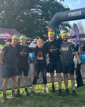 Amy James-Kelly Instagram - TOUGH MUDDER NORTH WEST 2023
••••
15km of mud, water, hills, and the wackiest obstacles since Richard Hammond and his Big Red Balls.
••••
Like Fall Guys, but real life, and you don't bounce if you fall. And you pay to do it. And you hurt for days after. And you run for way more than a couple of minutes. And there's no bright colours, it's all just grass and mud. So it's nothing like Fall Guys really. 
••••
I've been nervous about this for months - two surgeries later and I'm negotiating this event with a body that needs to do more than just train to run for a bit... There were obstacles I was on doctor's orders NOT to attempt (and I didn't, dw) But I conquered it. All 15k. And when I had to miss out an obstacle (like the two that electrocute you) I made sure I pelted it to the next one, just so no one could say I had an easy day of it 😜. We all crossed the finish line together, caked in mud, water, sheep shit, blood and sweat. And dya know what? I had a belting time. I have crap upper body strength so fell off every single set of monkey bars I crossed paths with (into the most horrible 'water'), but I did do two obstacles that triggered my claustrophobia so I'd say I redeemed myself...
••••
Matt, Will, Andy and of course Dan, who I absolutely not in a million years could have done this without, right from training to pulling me up the last few feet of that wall as I dangled from his arms. (And there's evidence within these photos that he had rather a nice time assisting me too, I guess... 😜)
••••
Can't wait to see the official photos from the event and be greeted by some ridiculous shots of me going arse over tit... @toughmudder