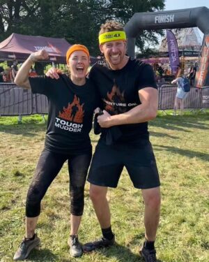 Amy James-Kelly Instagram - TOUGH MUDDER NORTH WEST 2023
••••
15km of mud, water, hills, and the wackiest obstacles since Richard Hammond and his Big Red Balls.
••••
Like Fall Guys, but real life, and you don't bounce if you fall. And you pay to do it. And you hurt for days after. And you run for way more than a couple of minutes. And there's no bright colours, it's all just grass and mud. So it's nothing like Fall Guys really. 
••••
I've been nervous about this for months - two surgeries later and I'm negotiating this event with a body that needs to do more than just train to run for a bit... There were obstacles I was on doctor's orders NOT to attempt (and I didn't, dw) But I conquered it. All 15k. And when I had to miss out an obstacle (like the two that electrocute you) I made sure I pelted it to the next one, just so no one could say I had an easy day of it 😜. We all crossed the finish line together, caked in mud, water, sheep shit, blood and sweat. And dya know what? I had a belting time. I have crap upper body strength so fell off every single set of monkey bars I crossed paths with (into the most horrible 'water'), but I did do two obstacles that triggered my claustrophobia so I'd say I redeemed myself...
••••
Matt, Will, Andy and of course Dan, who I absolutely not in a million years could have done this without, right from training to pulling me up the last few feet of that wall as I dangled from his arms. (And there's evidence within these photos that he had rather a nice time assisting me too, I guess... 😜)
••••
Can't wait to see the official photos from the event and be greeted by some ridiculous shots of me going arse over tit... @toughmudder